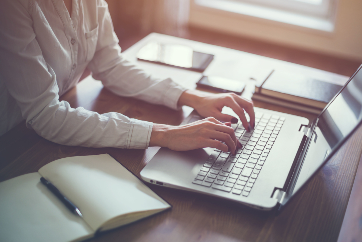 Woman typing on a laptop