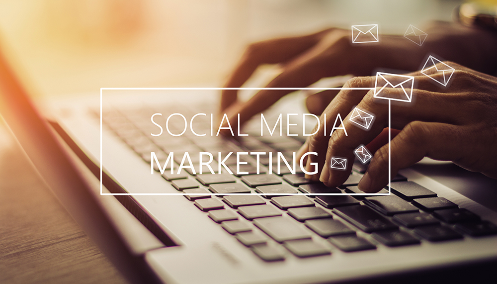 Social media marketing with hands typing on a laptop